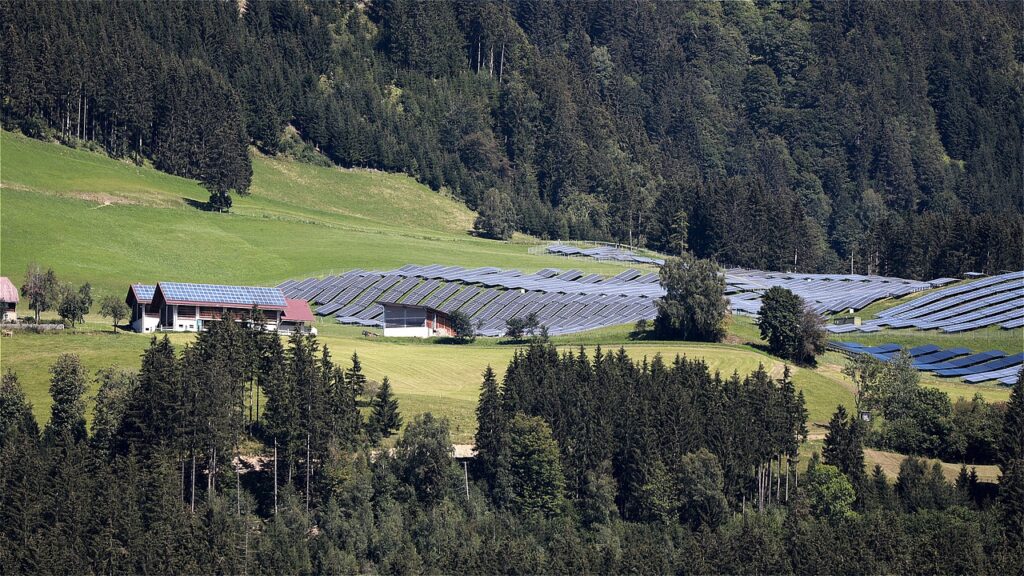 An expansive solar farm with rows of solar panels glistening in the sunlight